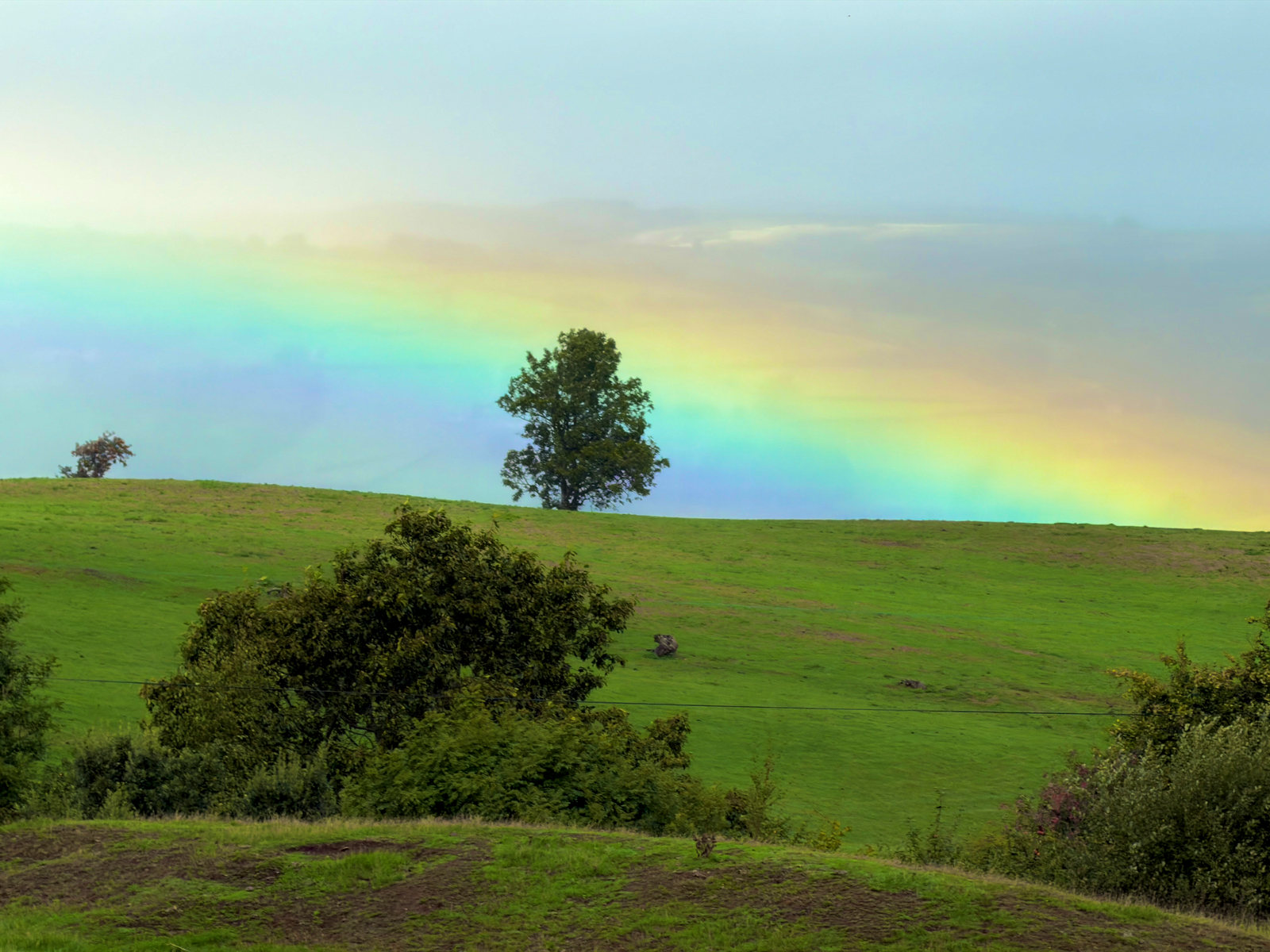 A rainbow above the green hills and fields of the borderlands.